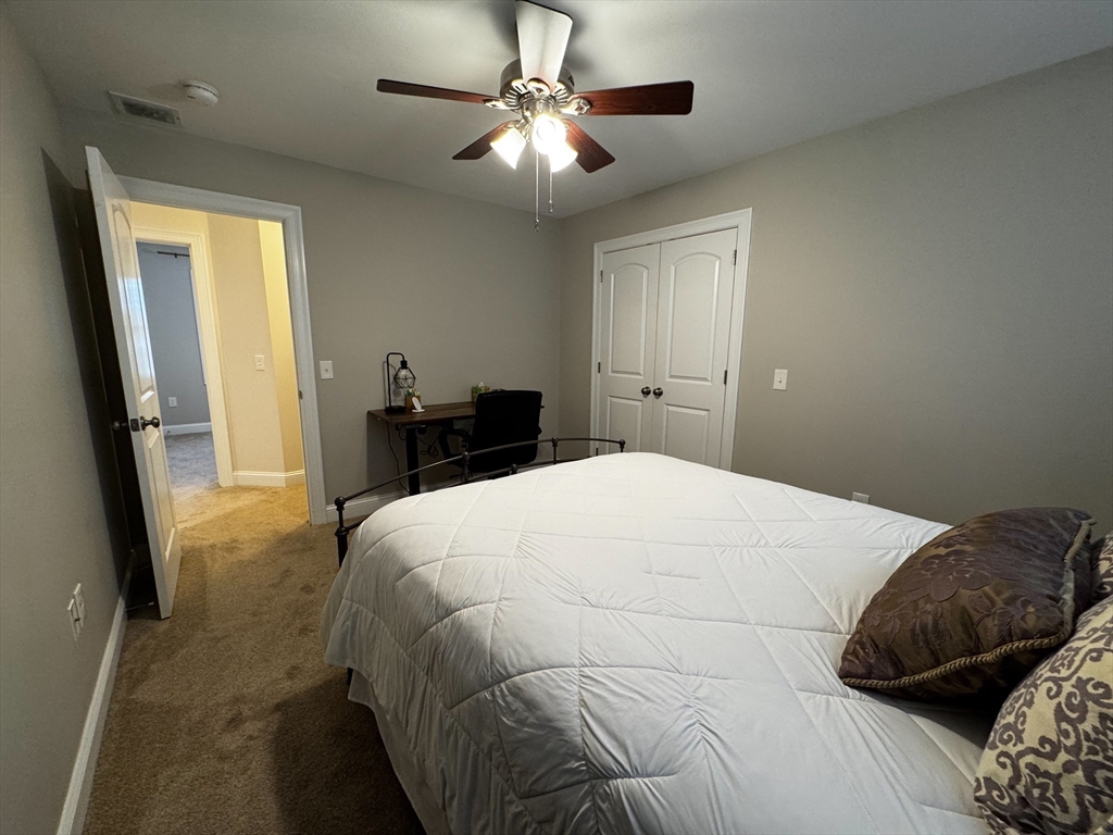 23 Ralph Street Chicopee, MA 01020 - Photo 29 of 42 a bedroom with a bed and a chandelier