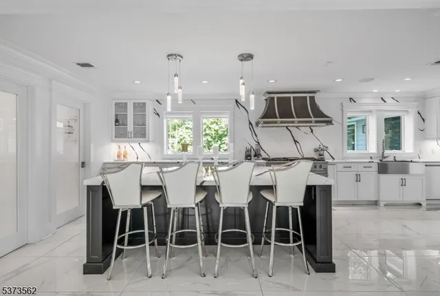 a kitchen with cabinets and chairs