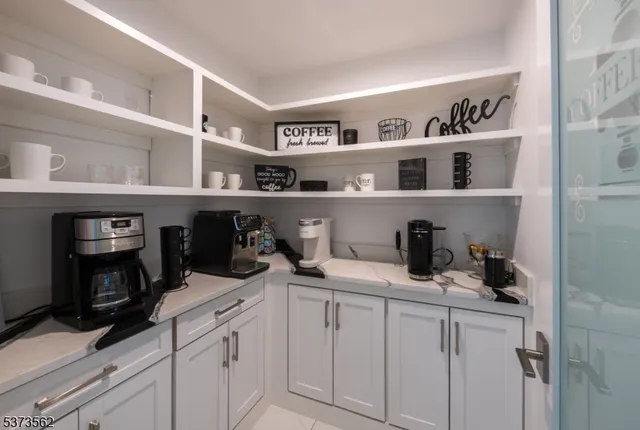 a view of cabinets a sink and a wooden floor in a kitchen