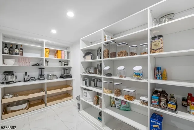 a kitchen with granite countertop a sink dishwasher stove and cabinets