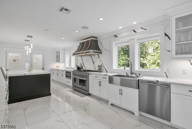 a kitchen with lots of counter top space and painting on the wall