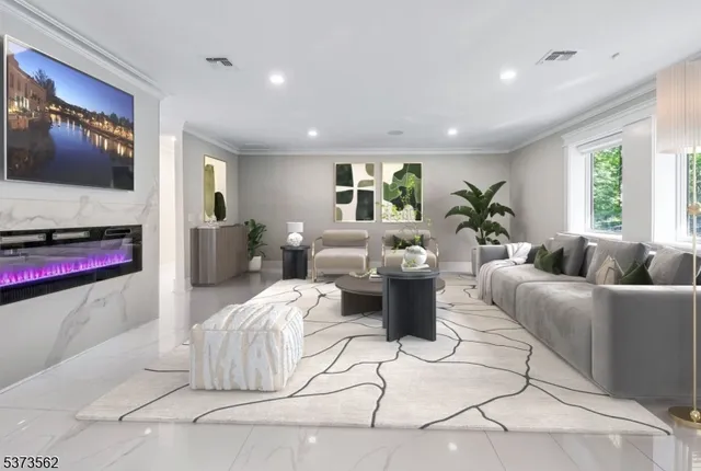 a living room with patio furniture and a large window