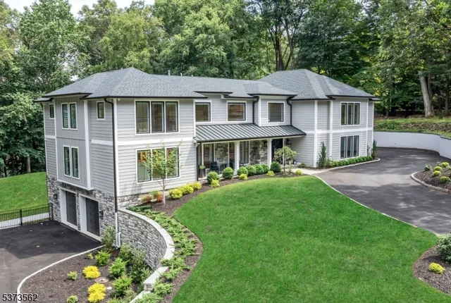 a front view of a house with a yard table and chairs