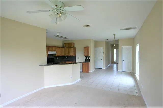 a view of a kitchen with a sink and a refrigerator