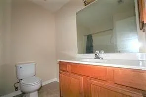 a bathroom with sink toilet and mirror
