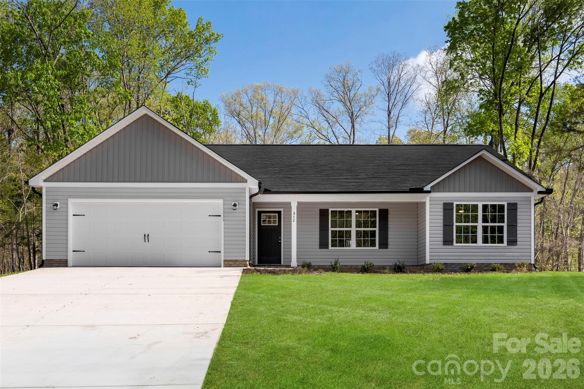 872 Roxboro Drive Mount Gilead, NC 27306 - Photo 1 of 41 a house with a tree in front of it