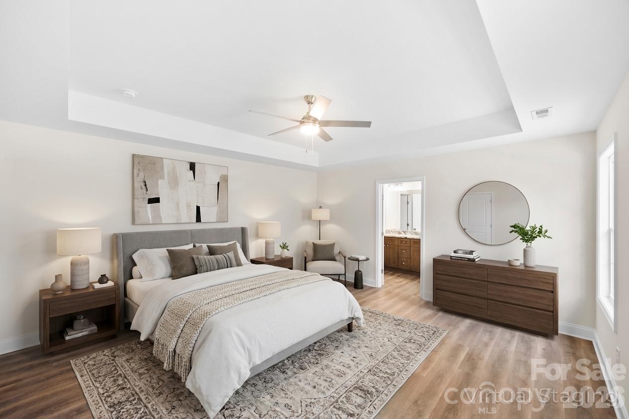 872 Roxboro Drive Mount Gilead, NC 27306 - Photo 14 of 41 a bedroom with a bed and a chandelier