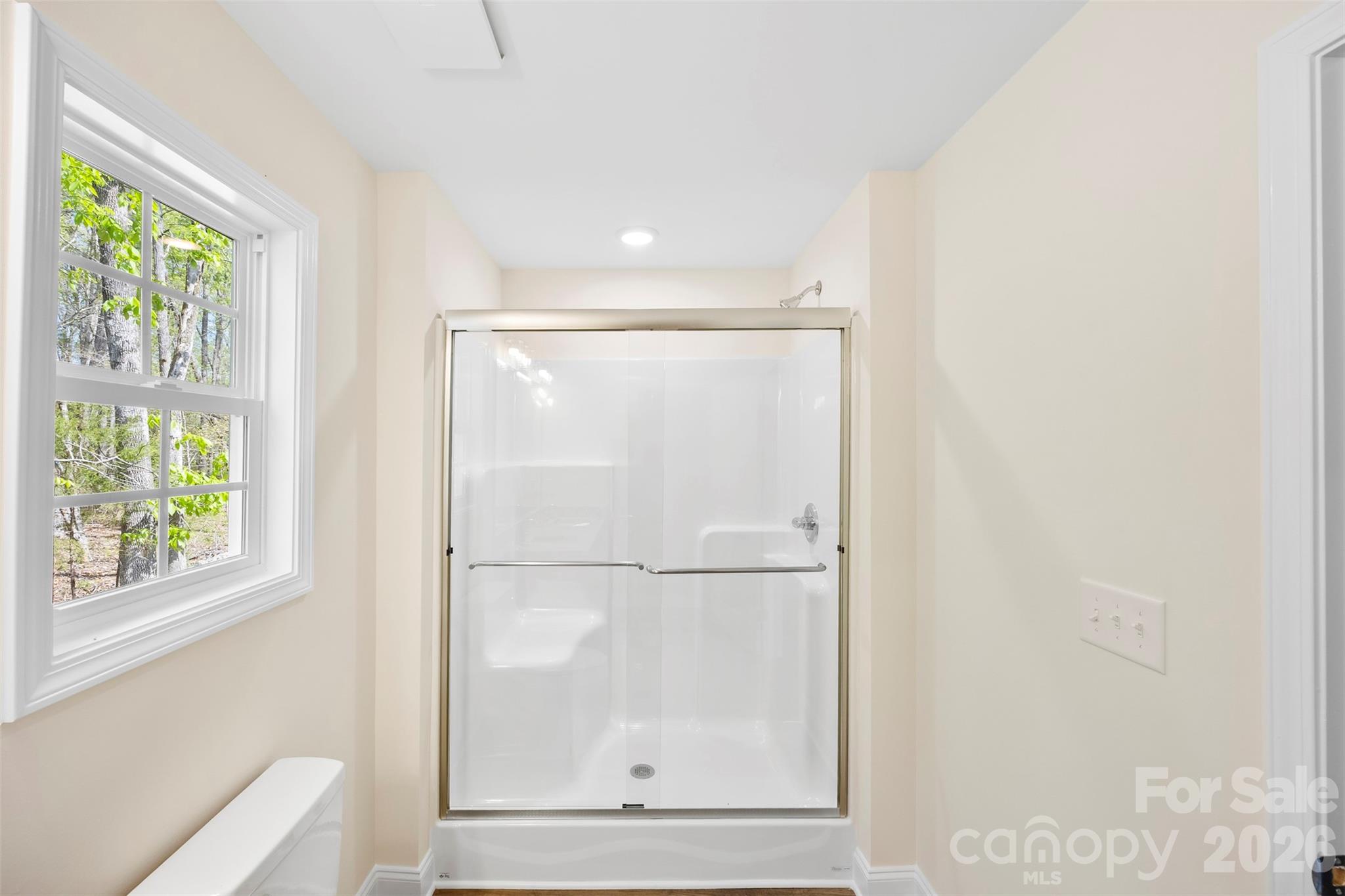 872 Roxboro Drive Mount Gilead, NC 27306 - Photo 18 of 41 a bathroom with a glass shower door