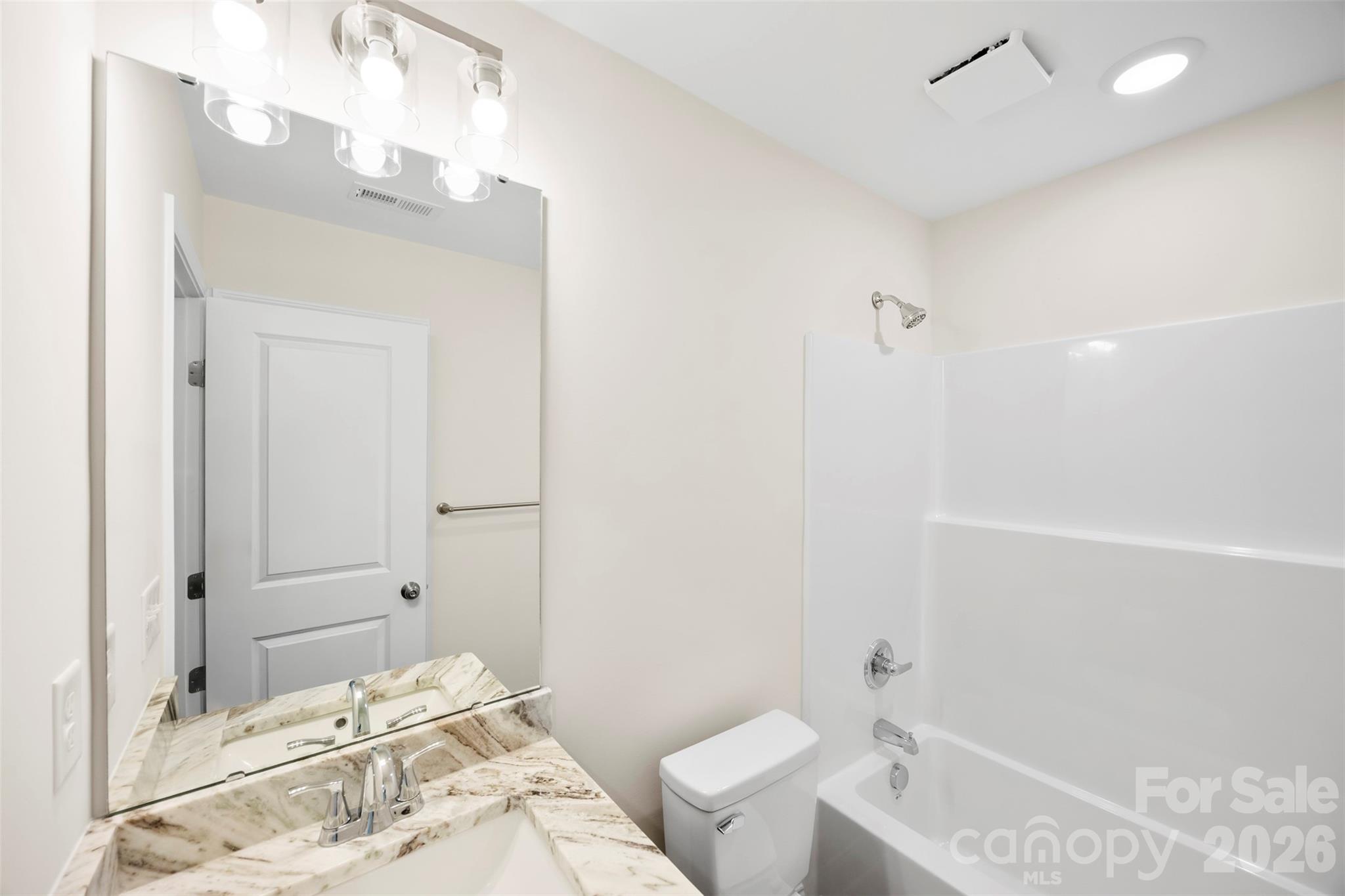 872 Roxboro Drive Mount Gilead, NC 27306 - Photo 23 of 41 a bathroom with a sink a toilet and shower