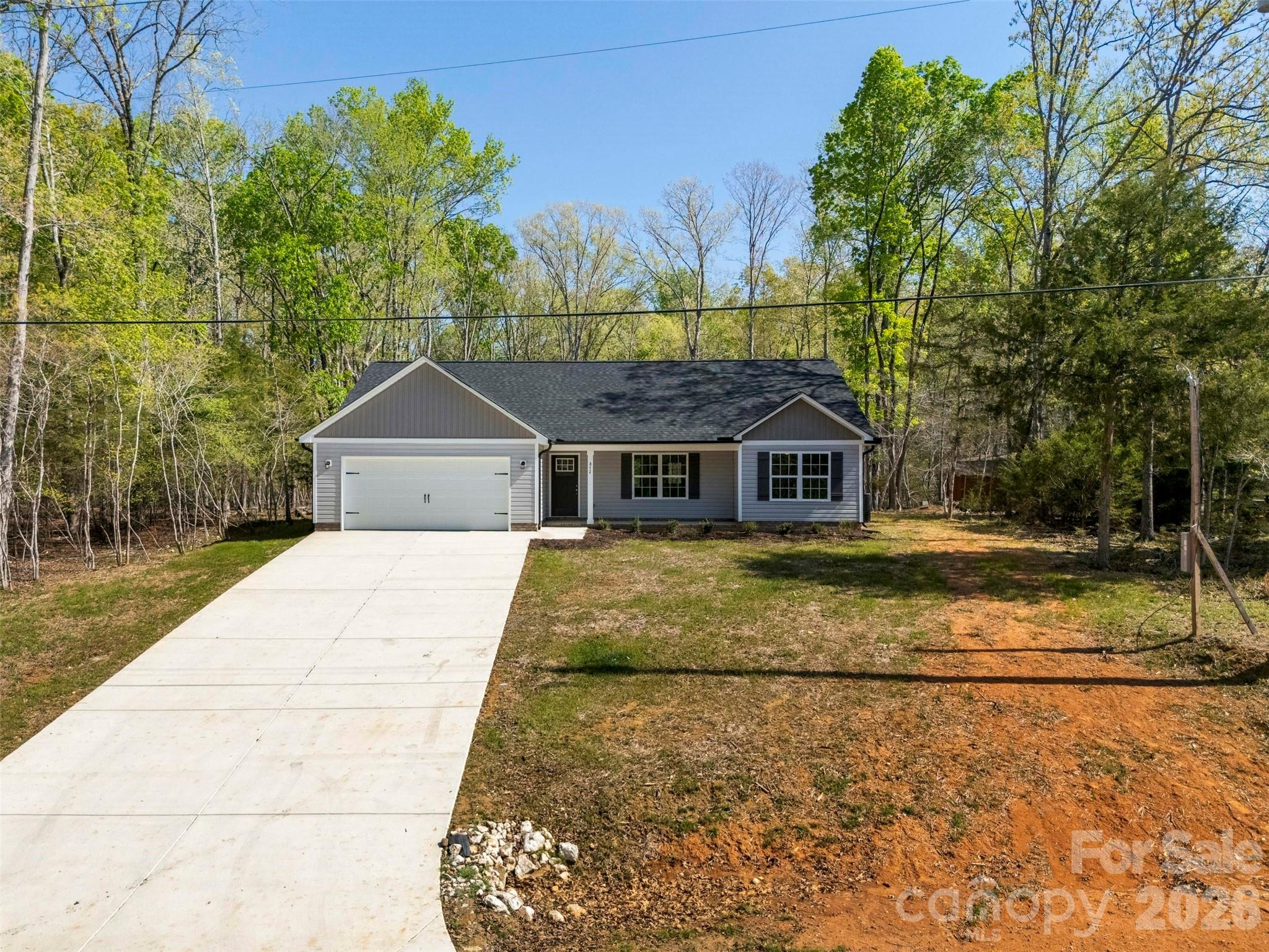 872 Roxboro Drive Mount Gilead, NC 27306 - Photo 37 of 41 a house with trees in the background