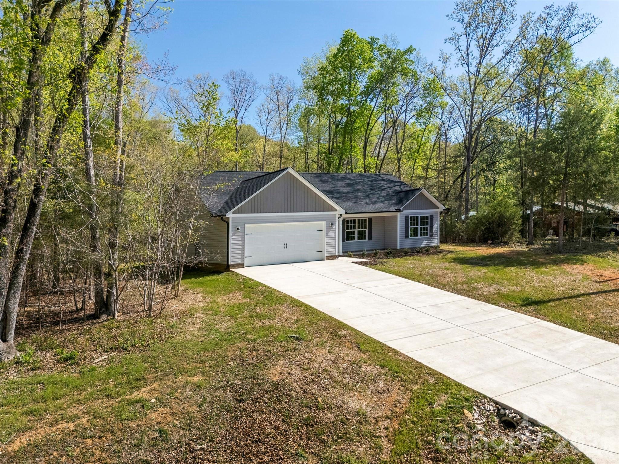 872 Roxboro Drive Mount Gilead, NC 27306 - Photo 39 of 41 a front view of a house with a yard and garage