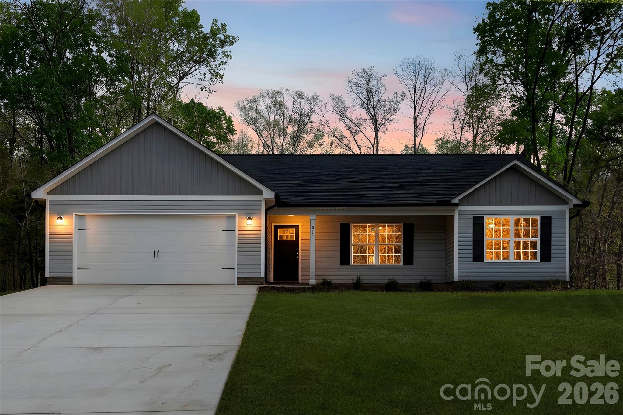 872 Roxboro Drive Mount Gilead, NC 27306 - Photo 5 of 41 a front view of a house with a yard and garage
