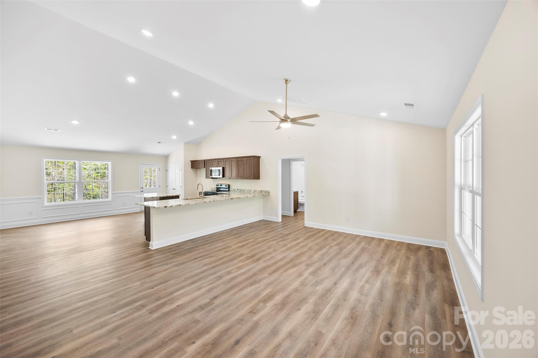 872 Roxboro Drive Mount Gilead, NC 27306 - Photo 8 of 41 a view of kitchen with cabinets and wooden floor