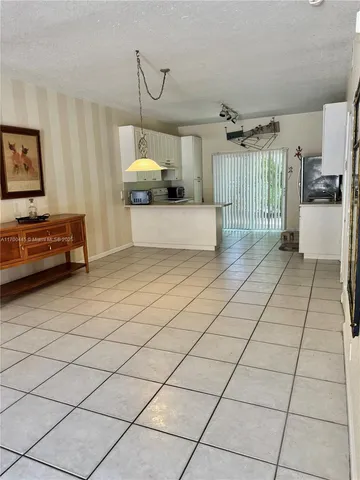 a kitchen with granite countertop a refrigerator and a sink
