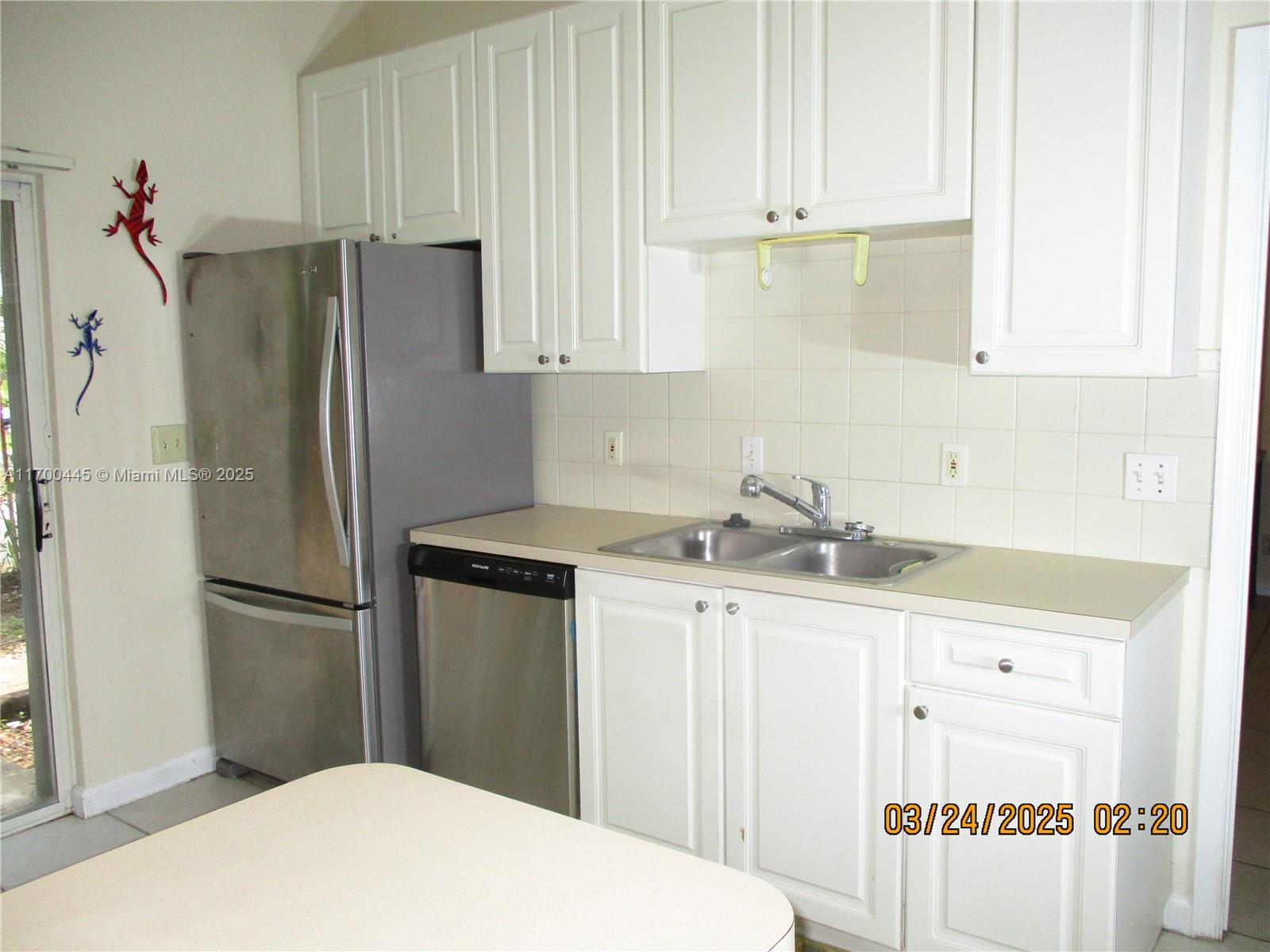 4802 Washington Street, Unit 2 Hollywood, FL 33021 - Photo 12 of 24 a kitchen with granite countertop a refrigerator and a sink