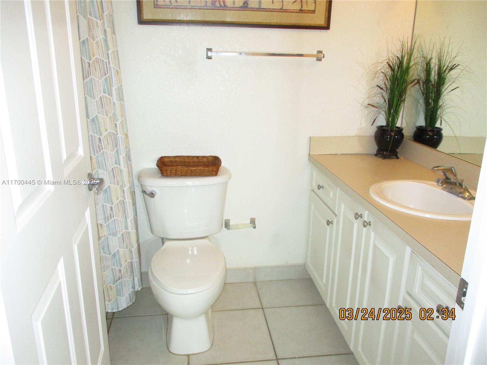 4802 Washington Street, Unit 2 Hollywood, FL 33021 - Photo 17 of 24 a bathroom with a sink a toilet and a mirror