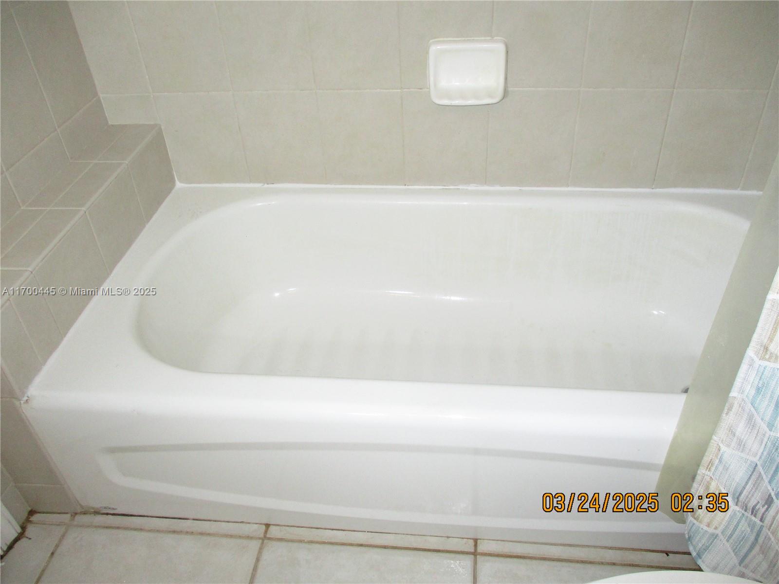 4802 Washington Street, Unit 2 Hollywood, FL 33021 - Photo 18 of 24 a bathroom with a bathtub