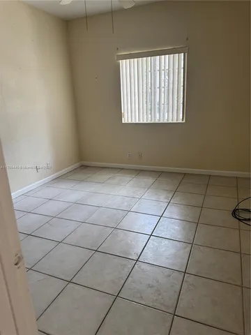a view of a hallway with furniture and a chandelier