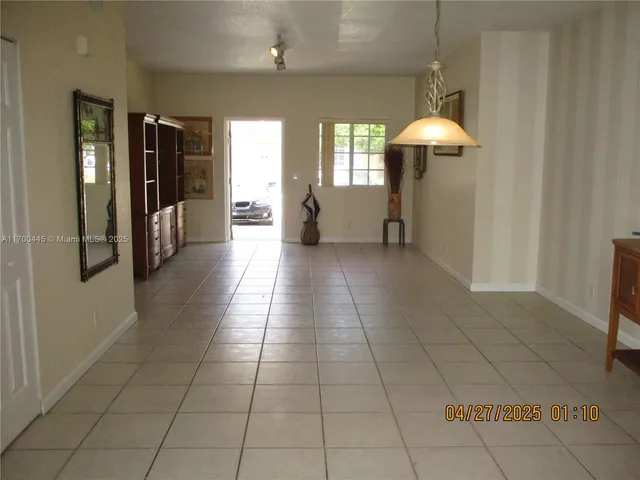 a kitchen with stainless steel appliances kitchen island granite countertop a refrigerator a stove and a sink with granite countertops