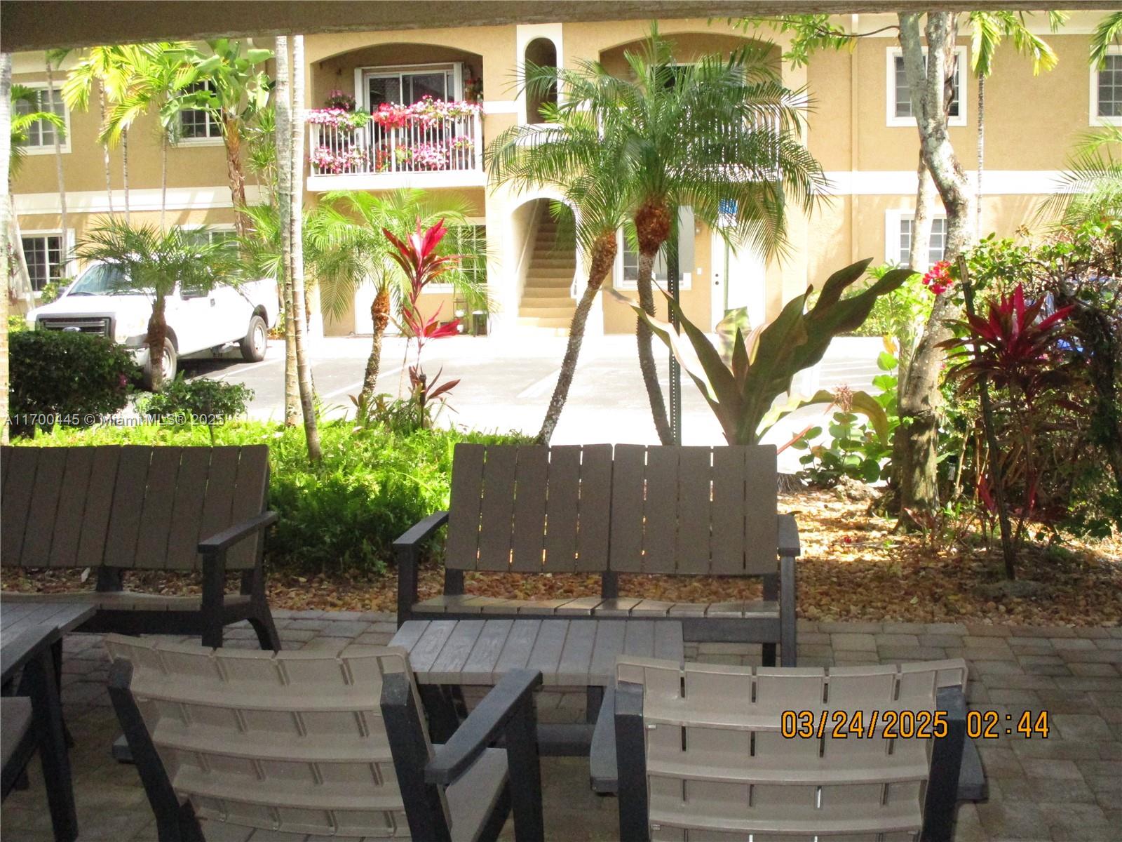 4802 Washington Street, Unit 2 Hollywood, FL 33021 - Photo 3 of 24 a view of a patio with table and chairs and potted plants