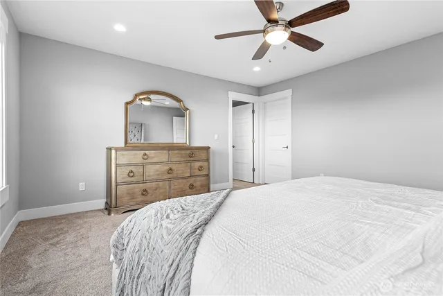 a bedroom with a bed and a dresser