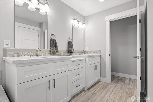 a bathroom with a granite countertop sink mirror and double