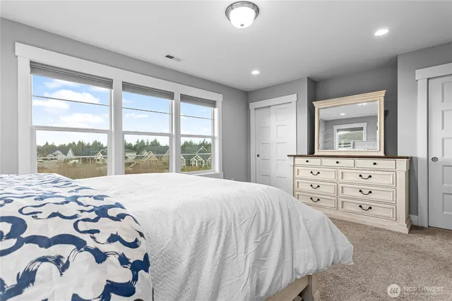 a bedroom with a bed and a closet