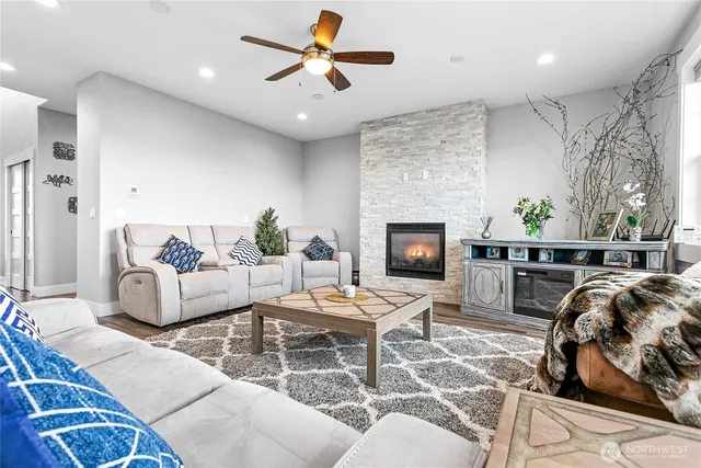 a living room with furniture a fireplace and a chandelier