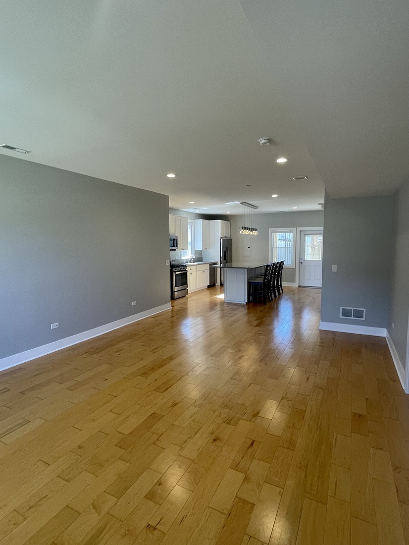 1986 Pine Street, Unit 1 Des Plaines, IL 60018 - Photo 2 of 11 a view of empty room with kitchen view