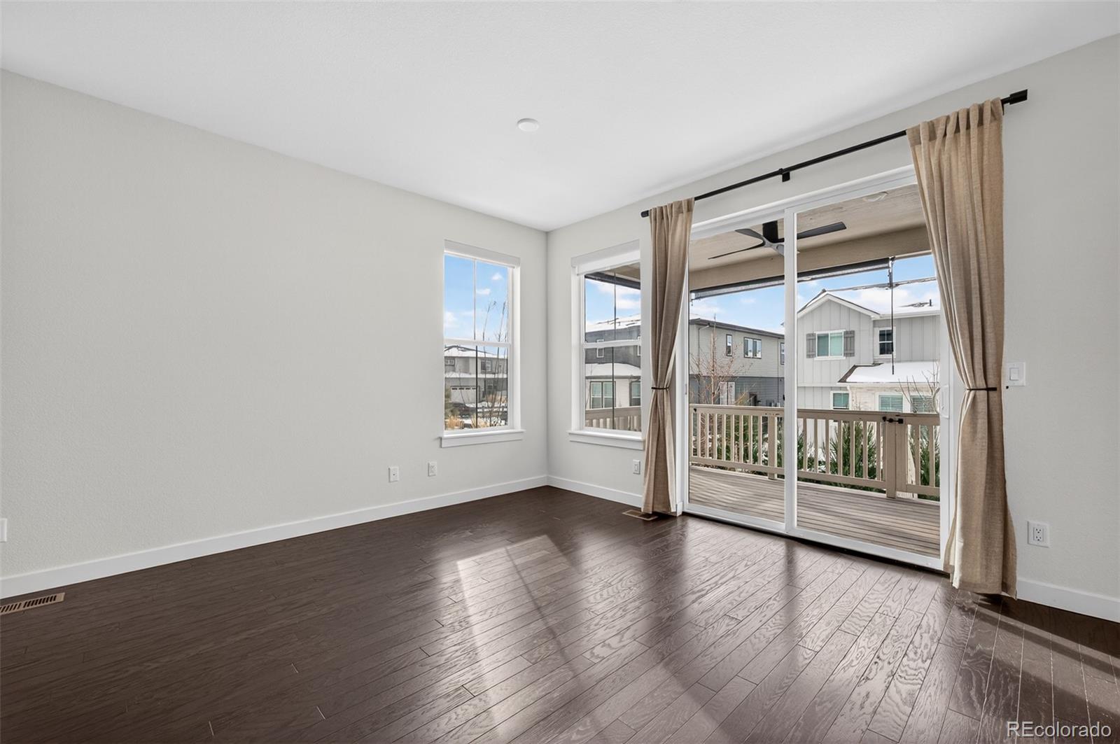6311 Stable View Street Castle Pines, CO 80108 - Photo 11 of 46 wooden floor in an empty room with a window