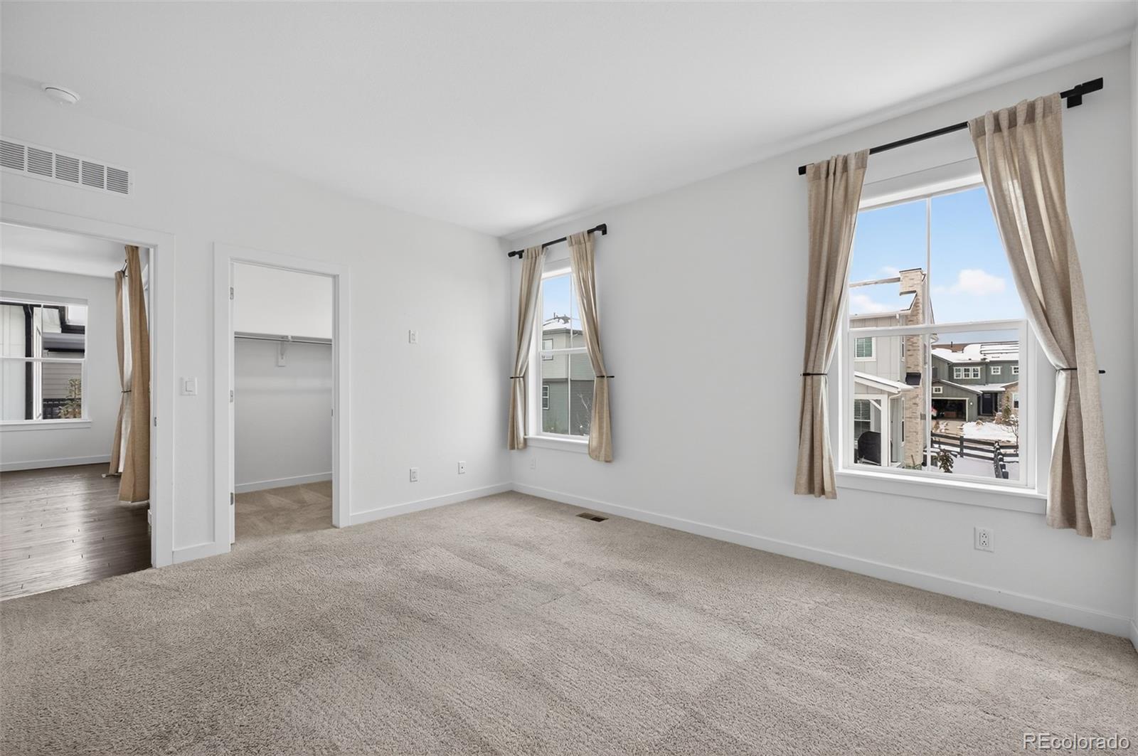 6311 Stable View Street Castle Pines, CO 80108 - Photo 12 of 46 an empty room with windows and cabinet