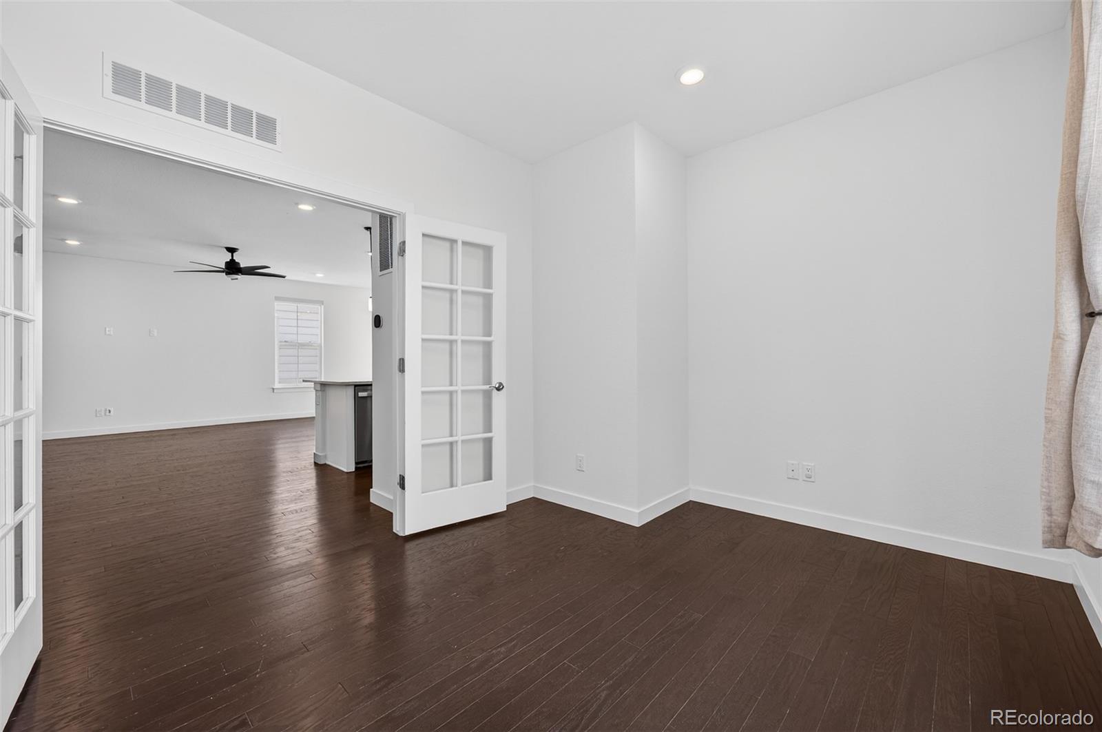 6311 Stable View Street Castle Pines, CO 80108 - Photo 18 of 46 a view of empty room with wooden floor