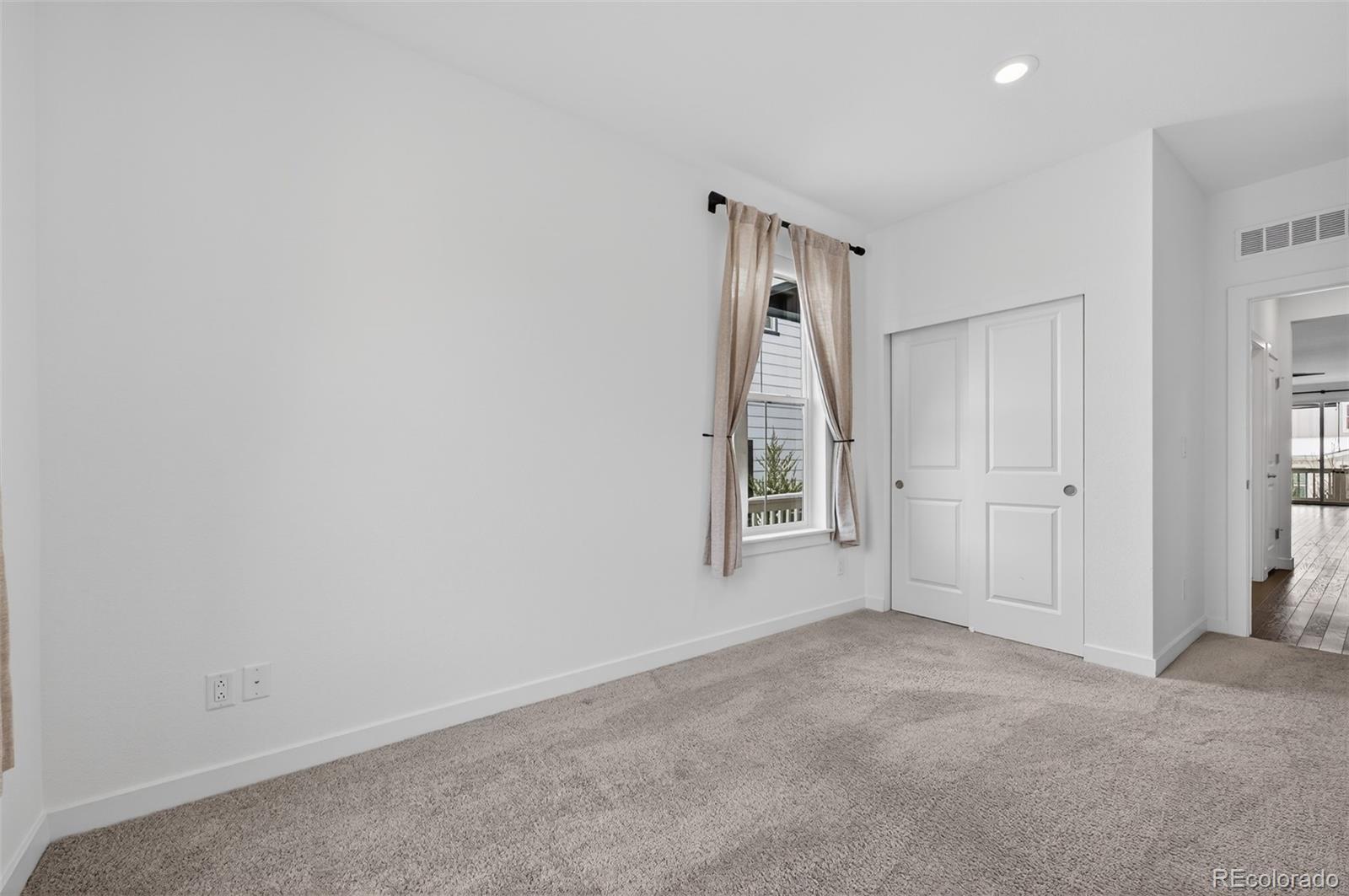 6311 Stable View Street Castle Pines, CO 80108 - Photo 22 of 46 an empty room with windows