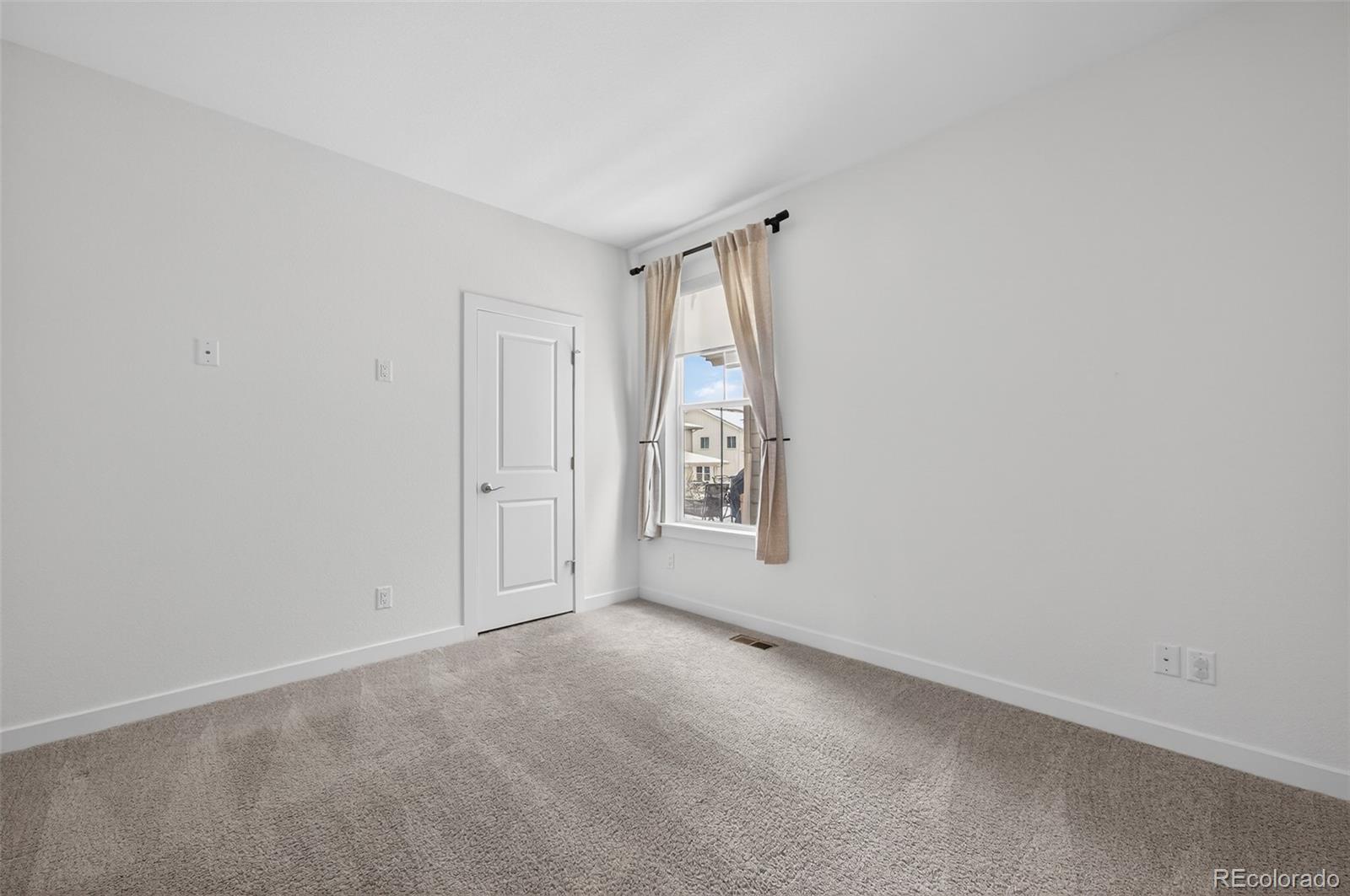6311 Stable View Street Castle Pines, CO 80108 - Photo 23 of 46 a view of an empty room with a window