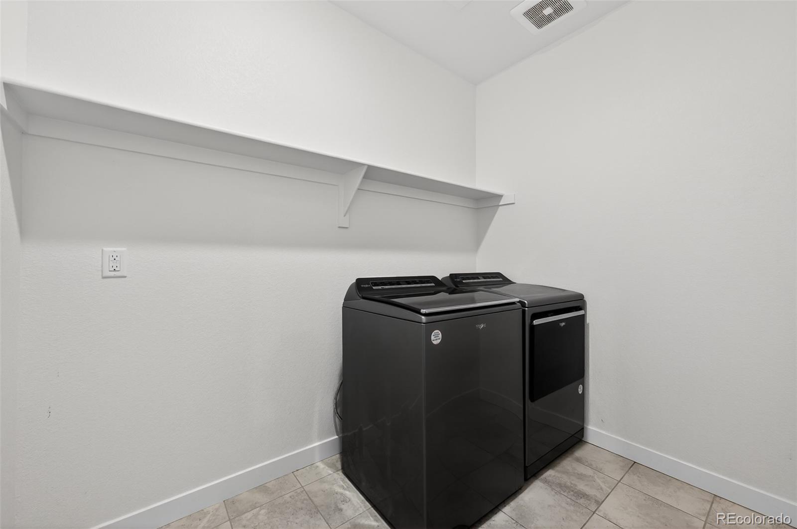 6311 Stable View Street Castle Pines, CO 80108 - Photo 26 of 46 a close up view of washer and dryer