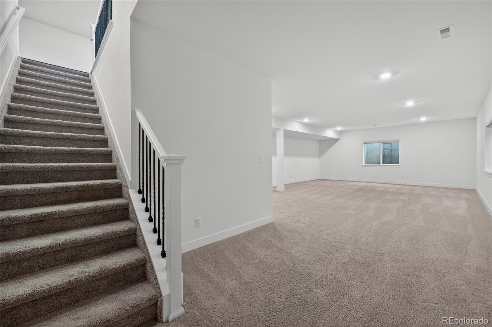 6311 Stable View Street Castle Pines, CO 80108 - Photo 27 of 46 a view of an empty room with stairs
