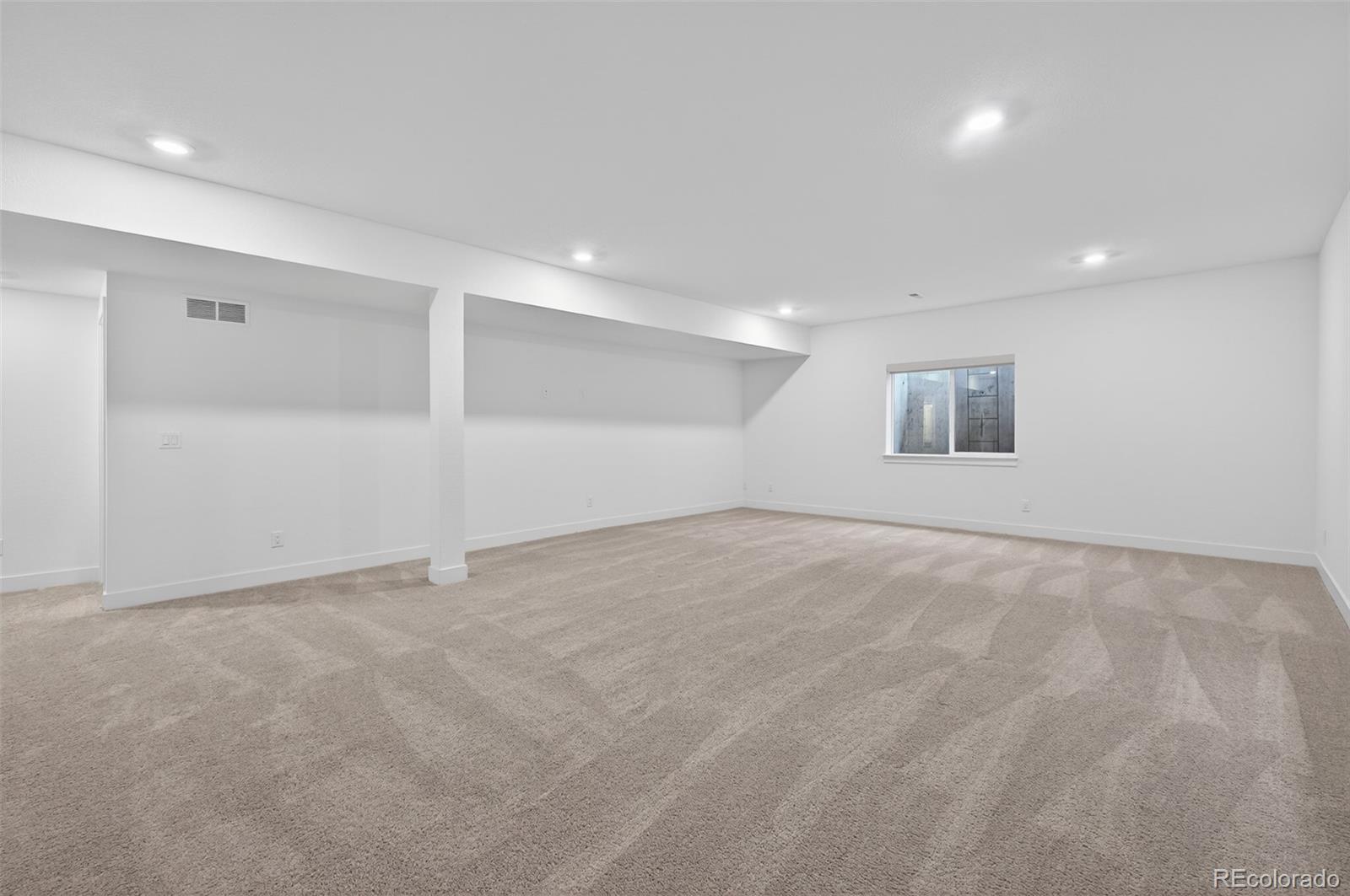 6311 Stable View Street Castle Pines, CO 80108 - Photo 28 of 46 an empty room with white walls and windows