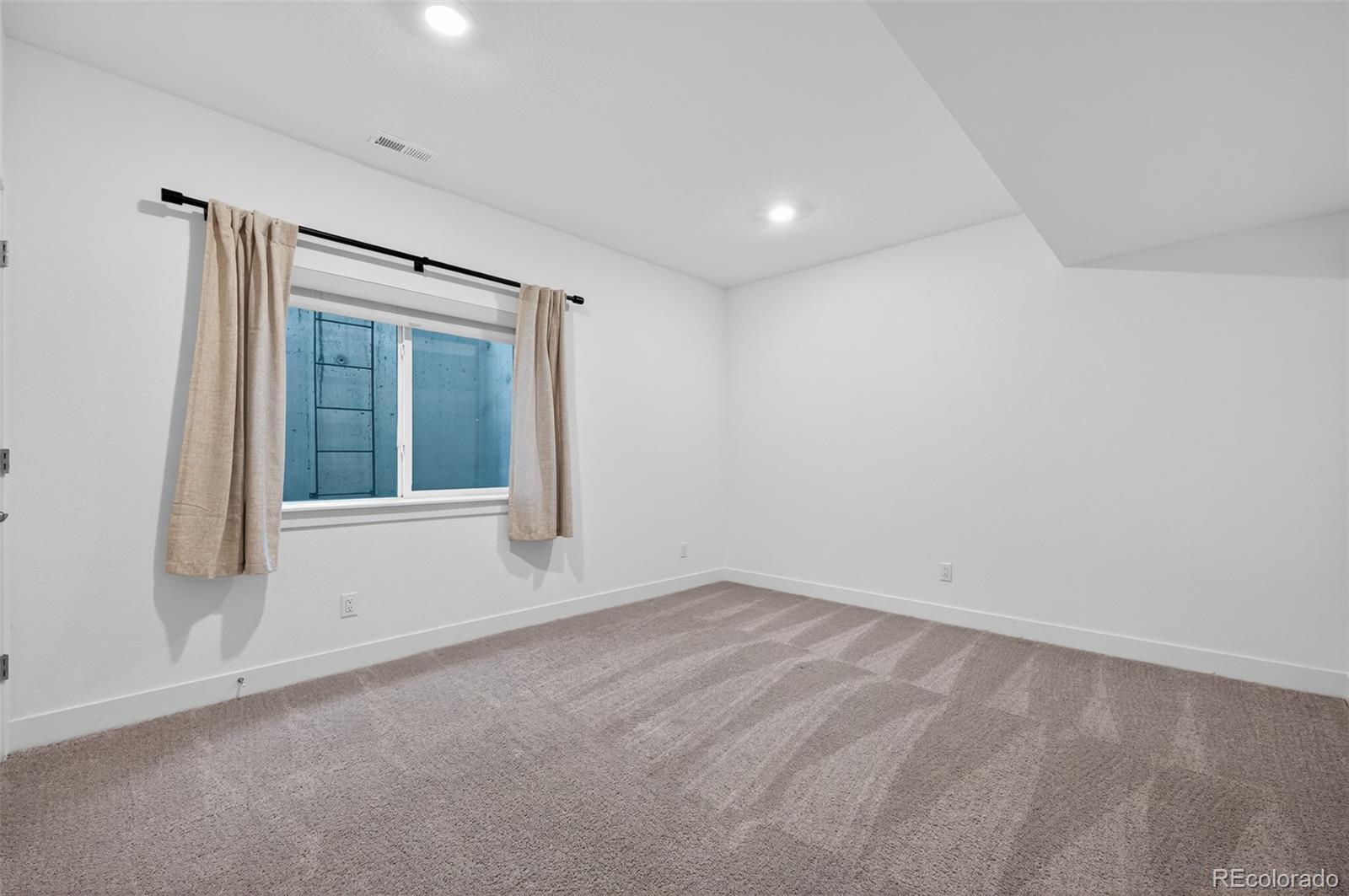 6311 Stable View Street Castle Pines, CO 80108 - Photo 31 of 46 a view of an empty room with a window
