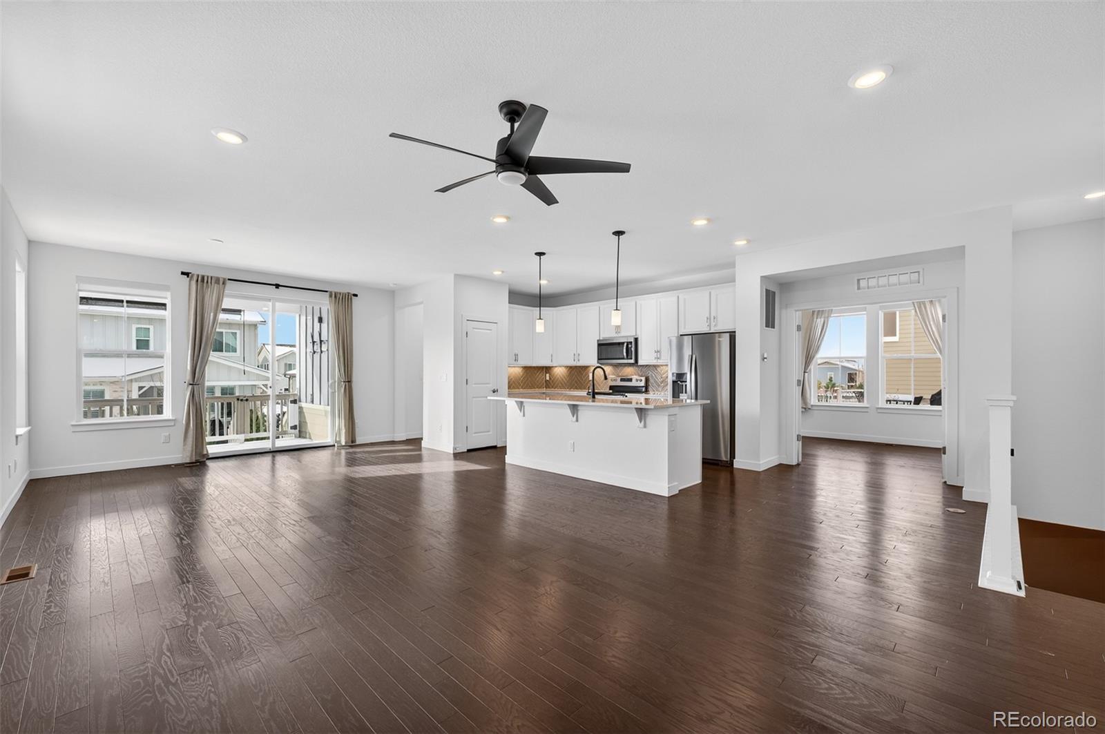6311 Stable View Street Castle Pines, CO 80108 - Photo 4 of 46 a view of kitchen with cabinets and wooden floor