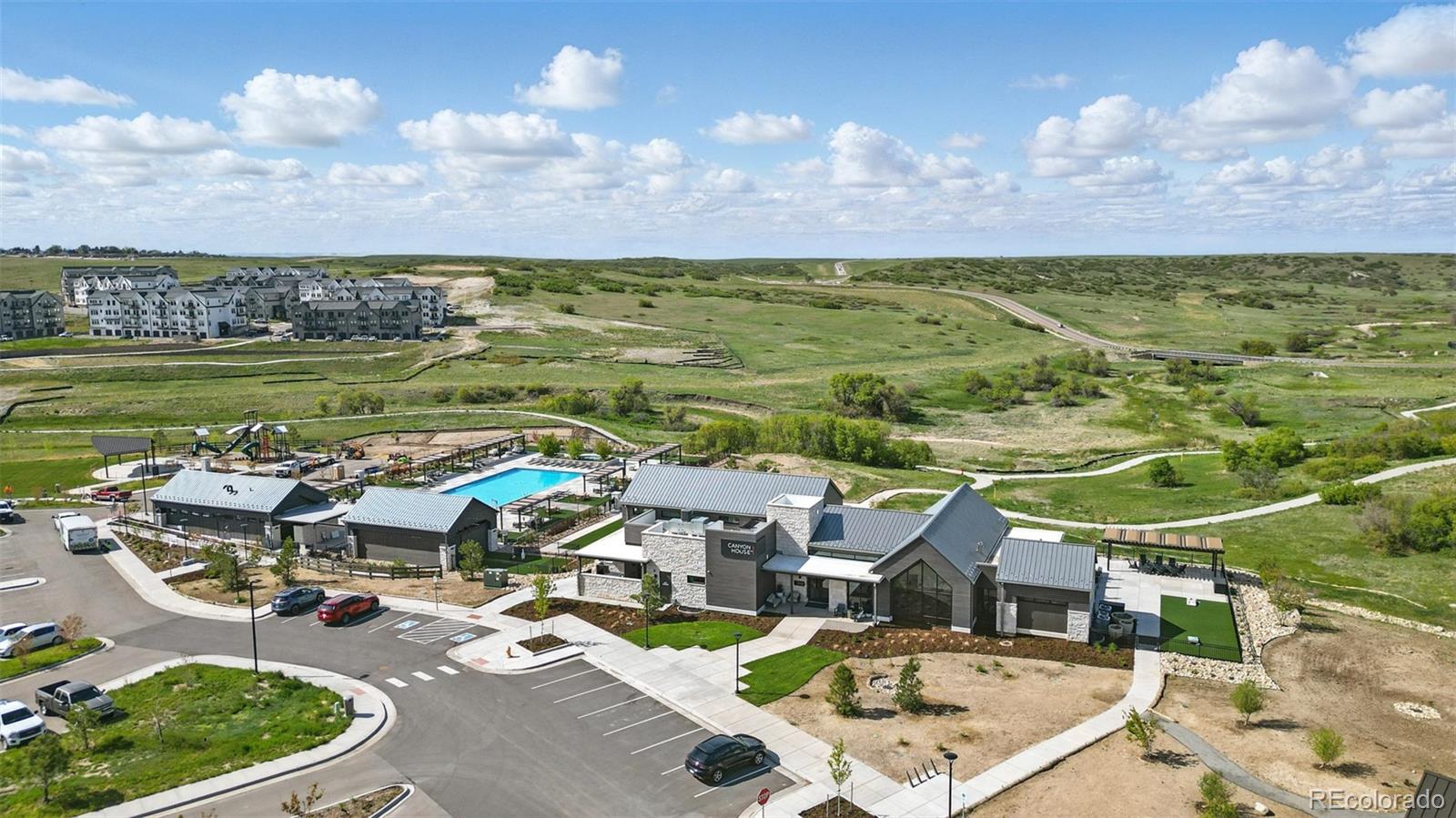 6311 Stable View Street Castle Pines, CO 80108 - Photo 42 of 46 a picture of a city with lots of residential buildings ocean and mountain view in back