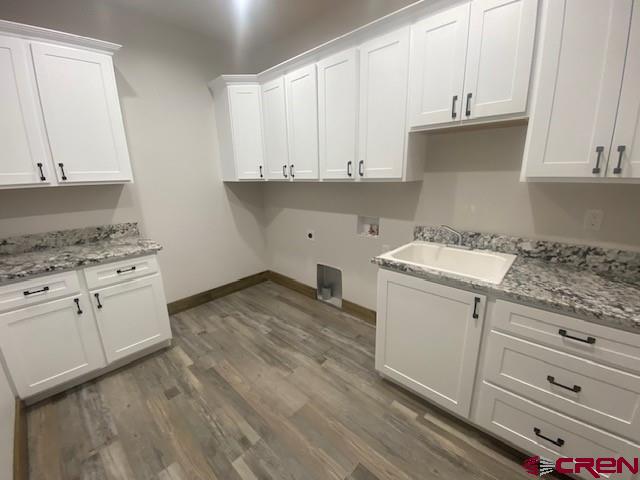 8896 Road 26.7 Loop Cortez, CO 81321 - Photo 9 of 20 a kitchen with granite countertop white cabinets and white appliances