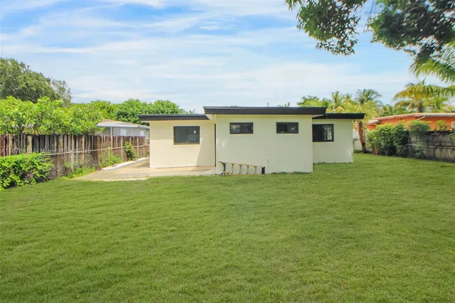 a front view of house with yard and lake