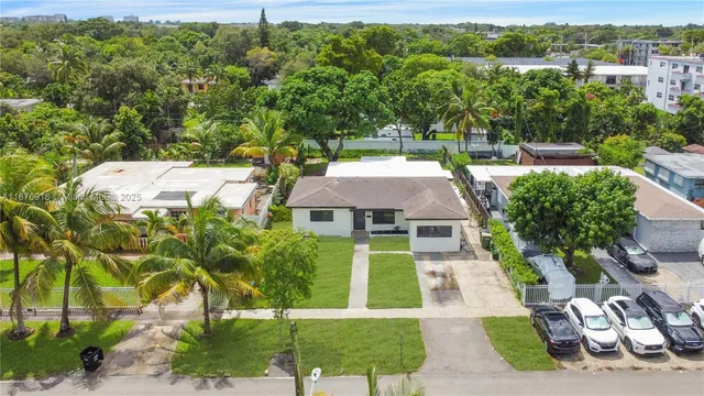 an aerial view of a house with a yard
