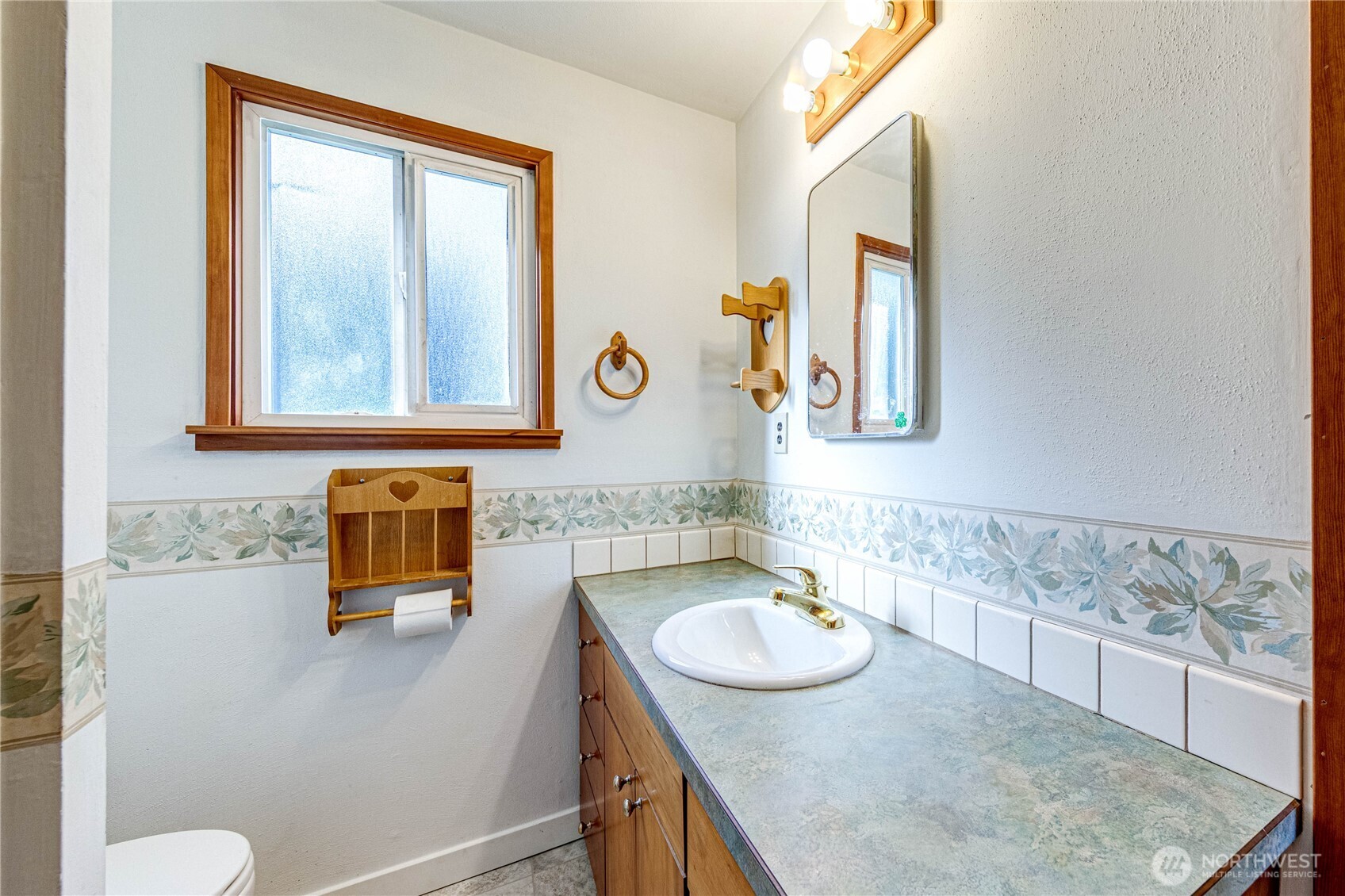 1520 Scrivner Road Port Angeles, WA 98362 - Photo 19 of 40 a bathroom with a granite countertop sink and a mirror