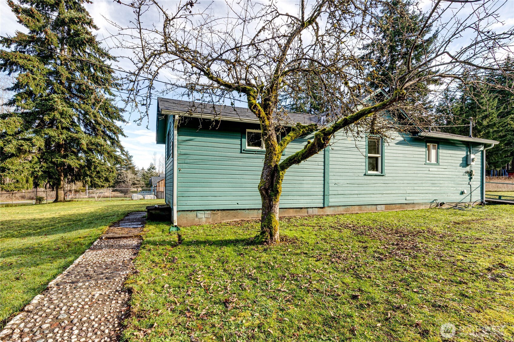 1520 Scrivner Road Port Angeles, WA 98362 - Photo 29 of 40 a backyard of a house with plants and large tree