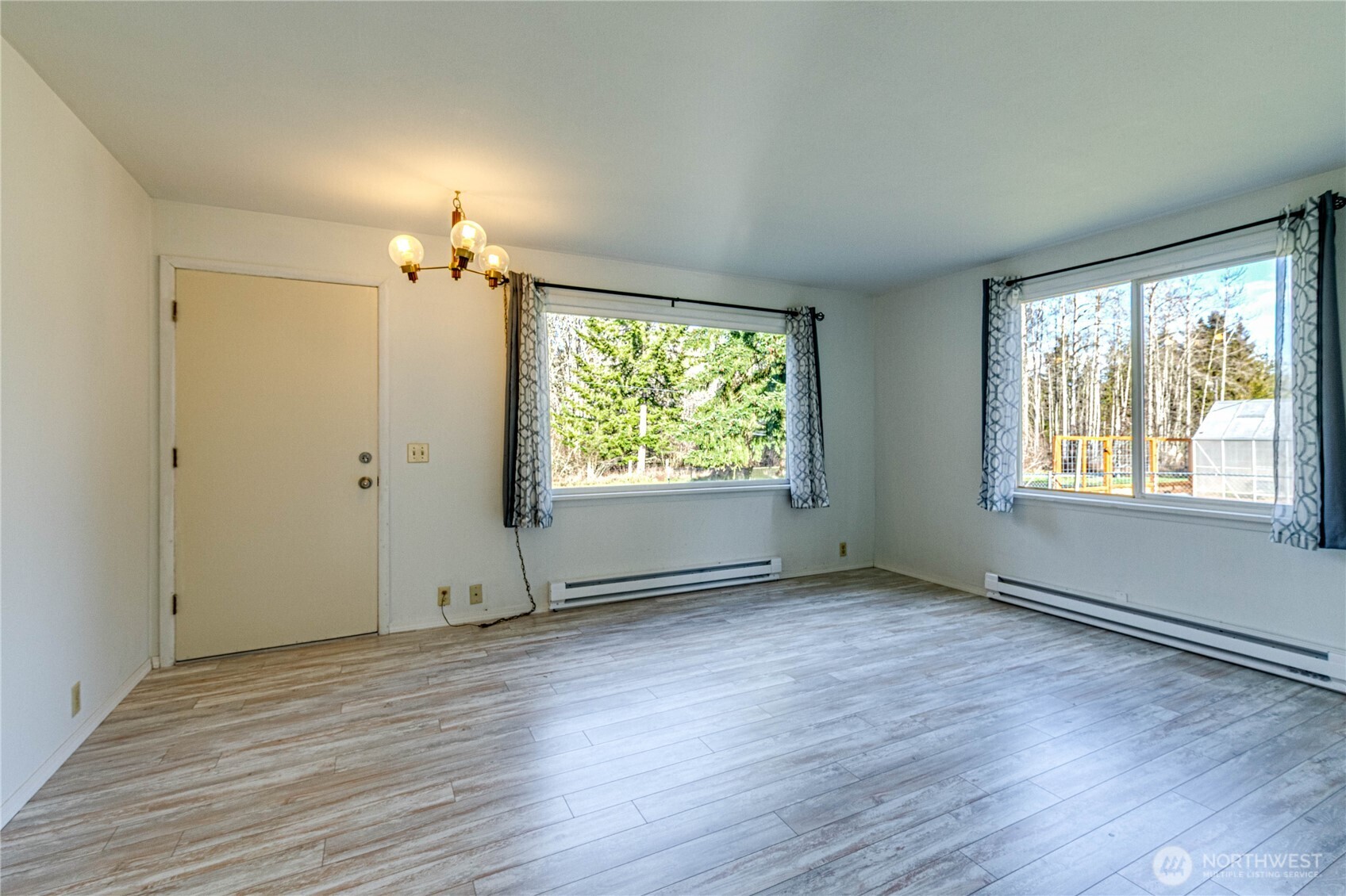 1520 Scrivner Road Port Angeles, WA 98362 - Photo 6 of 40 an empty room with wooden floor cabinet and windows