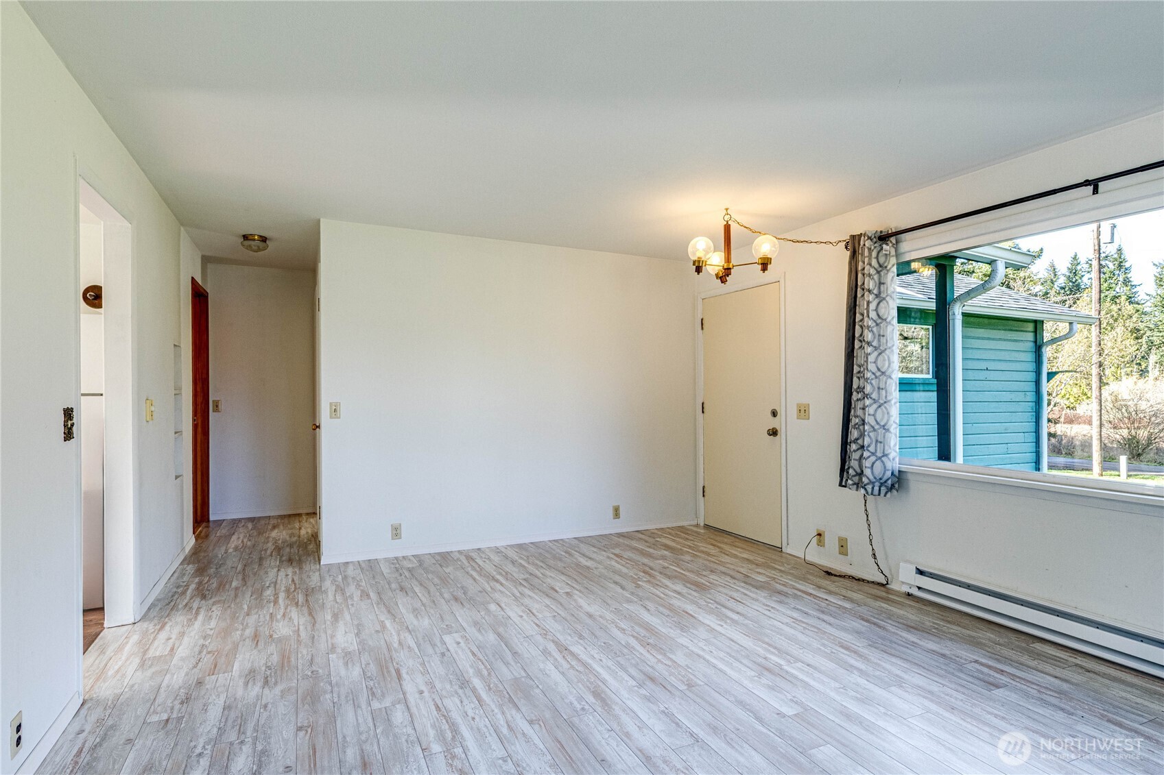 1520 Scrivner Road Port Angeles, WA 98362 - Photo 8 of 40 an empty room with wooden floor and windows