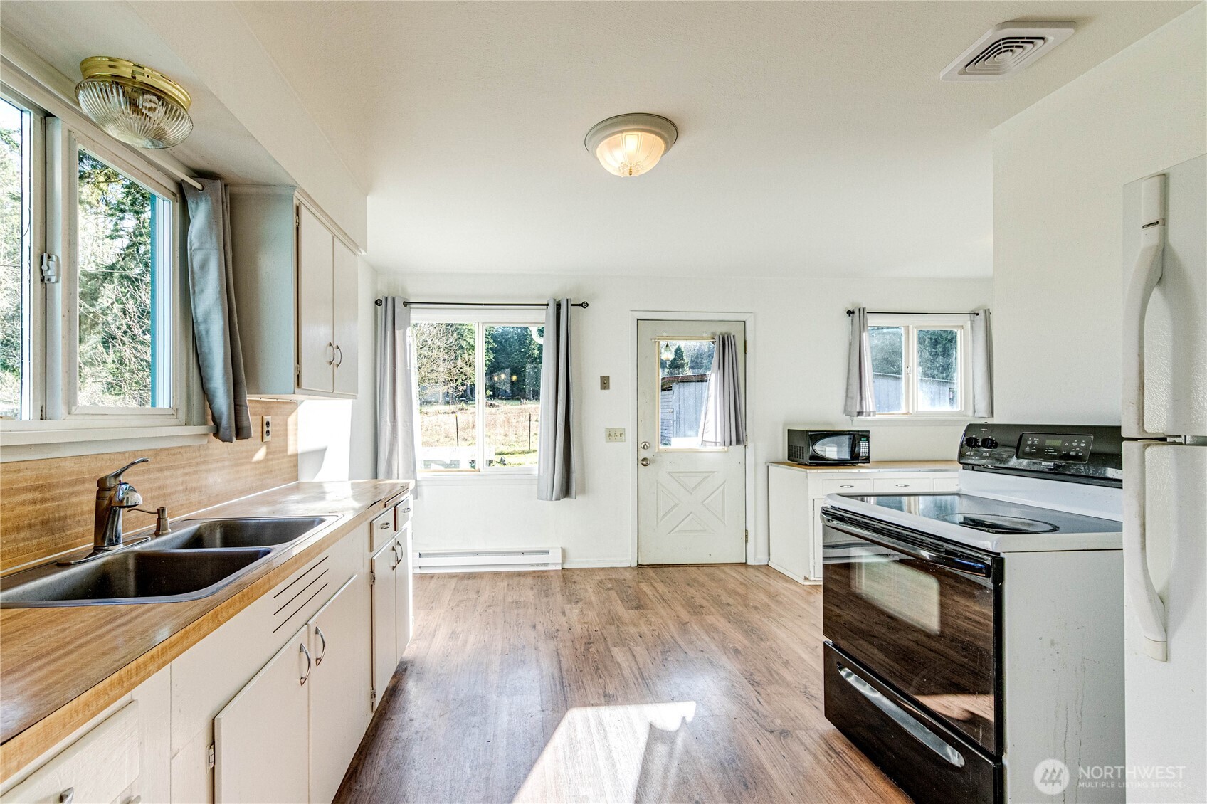 1520 Scrivner Road Port Angeles, WA 98362 - Photo 9 of 40 a kitchen with a stove a sink and a window