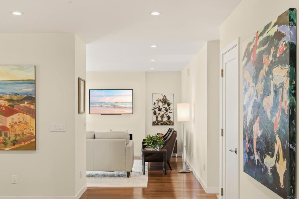5958 Sagebrush Road La Jolla, CA 92037 - Photo 11 of 64 a view of a hallway with wooden floor and a potted plant