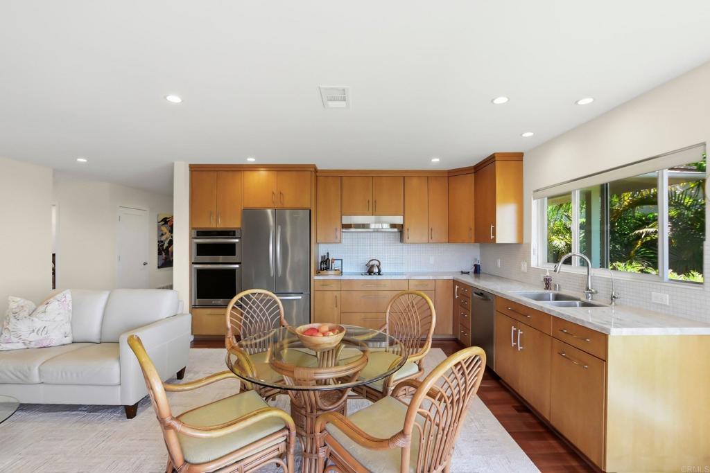 5958 Sagebrush Road La Jolla, CA 92037 - Photo 14 of 64 a kitchen with stainless steel appliances granite countertop a sink and a refrigerator
